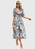 Woman wearing the Rosalie floral midi dress showcasing the comfortable smocked waist and vibrant print