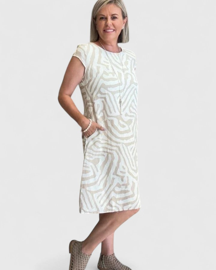 Woman wearing the Callista flared A-line dress highlighting the dramatic bell-style sleeves
