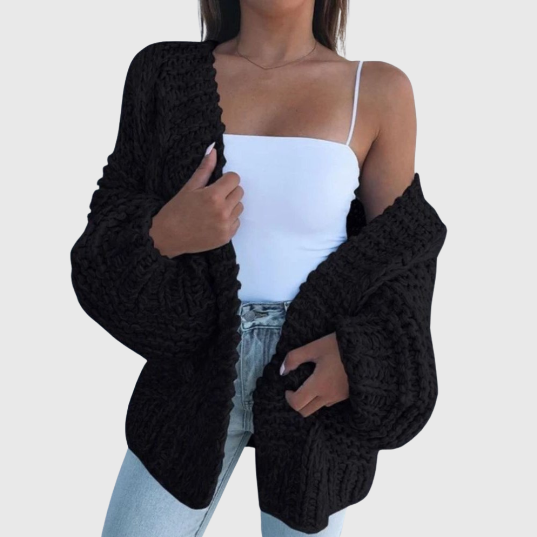 Yvanderliah chunky knit cardigan draped loosely over a casual t-shirt