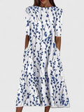 Bright floral print on the Karina midi dress styled for a sunny outdoor setting