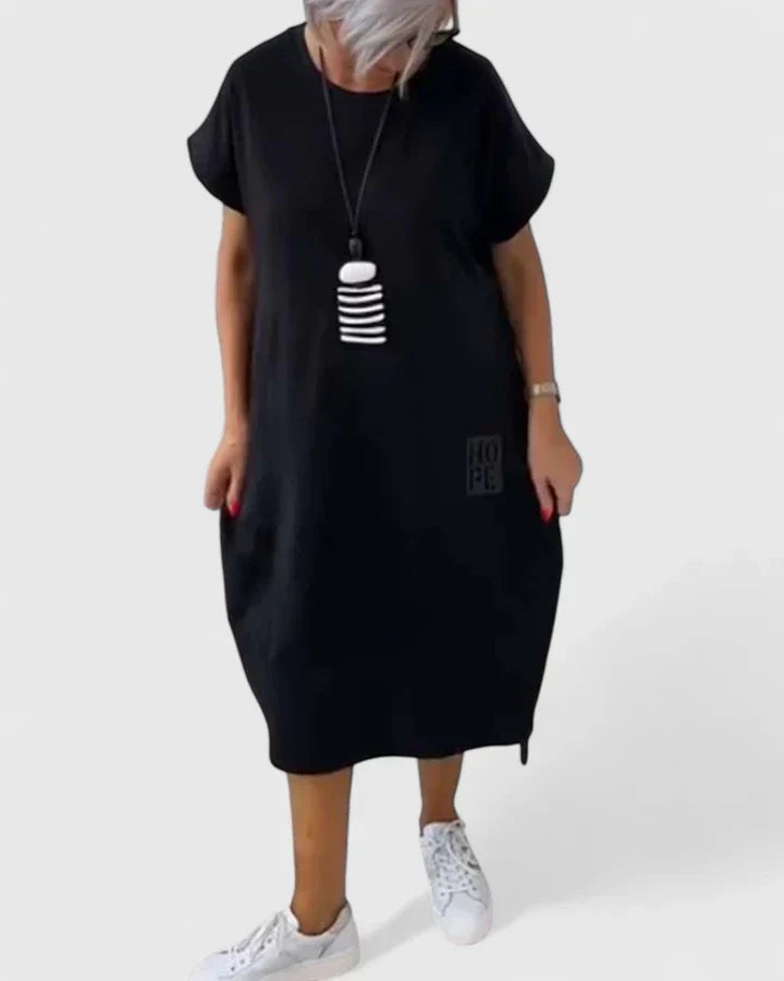Audrey comfortable midi dress styled for everyday wear showing off its loose fit and pockets