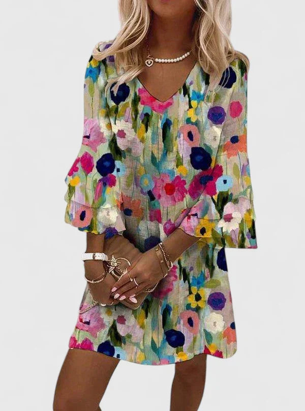 Model wearing the playful Clarissa romantic floral mini dress with a V-neckline