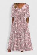 Cora polka dot midi dress featuring a flattering V-neck cut worn in an outdoor urban setting