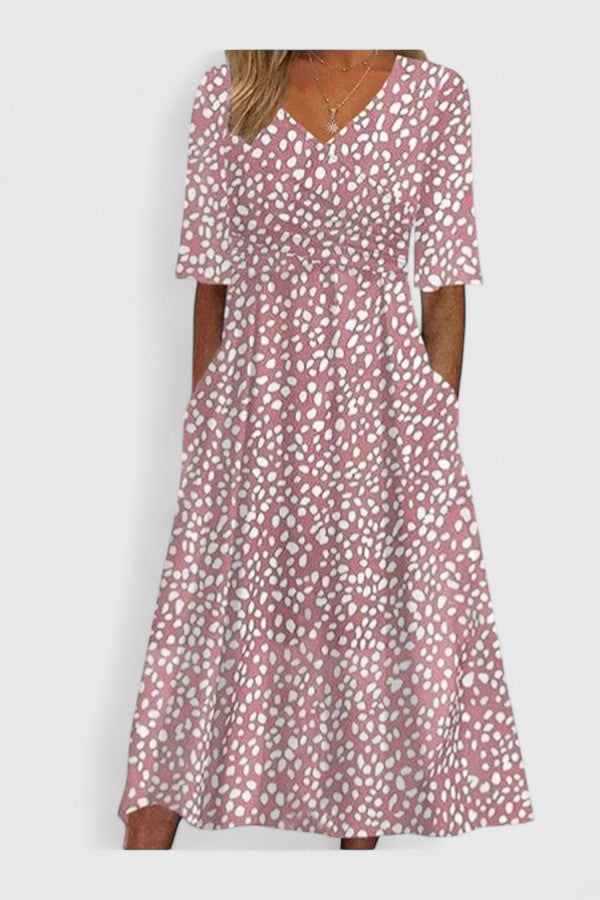 Cora polka dot midi dress featuring a flattering V-neck cut worn in an outdoor urban setting