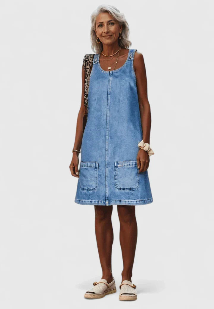 Dominique denim midi dress featuring large front utility pockets and a relaxed cut