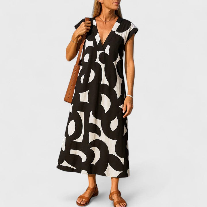 Valery breezy V-neck printed dress flowing gracefully in a summer setting