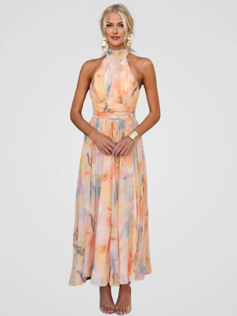 Woman wearing the breezy Cordelia halter midi dress with a soft watercolor floral print